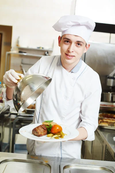 Cook chef with food in kitchen — Stock Photo, Image