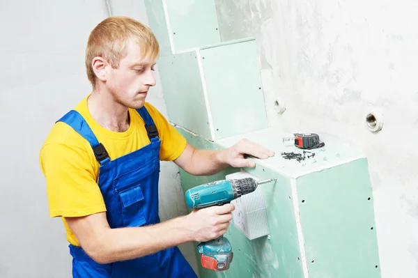 Carpenter with plasterboard and screwdriver — Stock Photo, Image