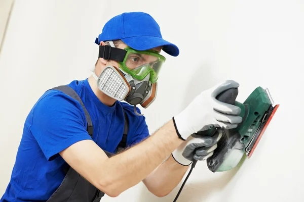 Plasterer worker with sander at wall filling — Stock Image Plasterer worker with sander at wall filling Stock Picture