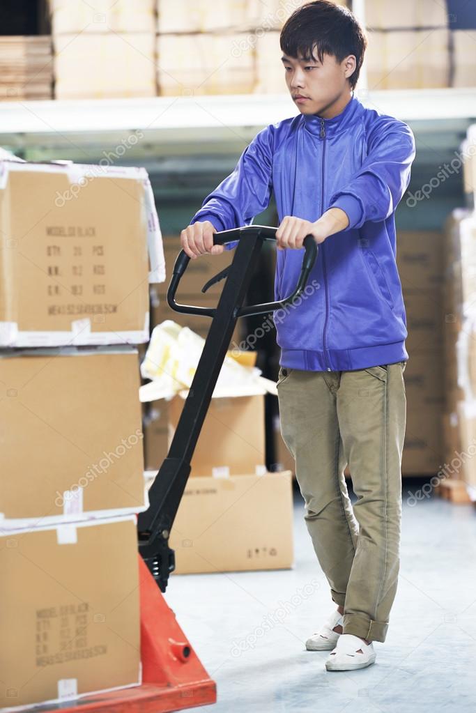 chinese warehouse worker with forklift stacker