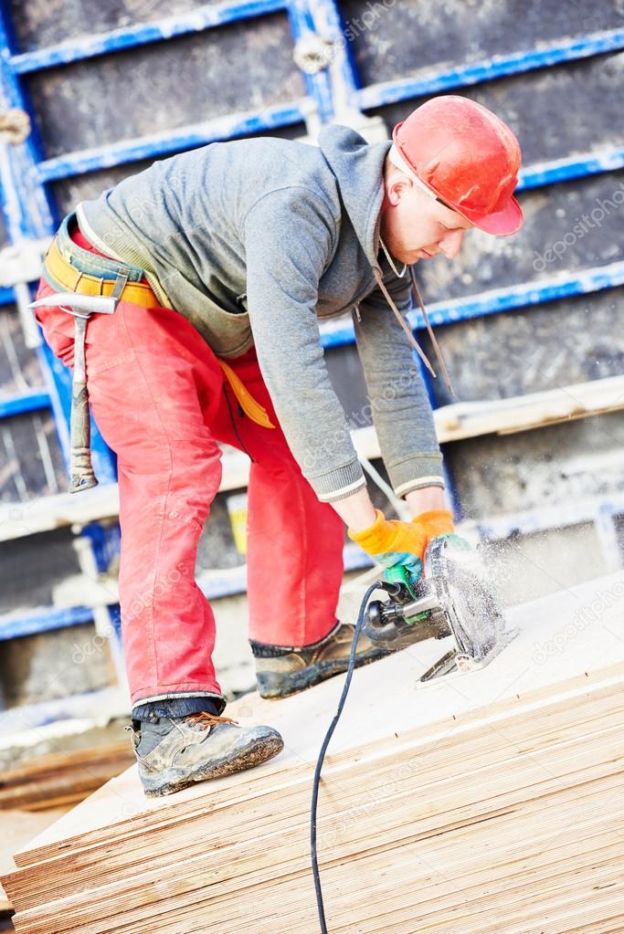 worker cutting plywood by saw machine