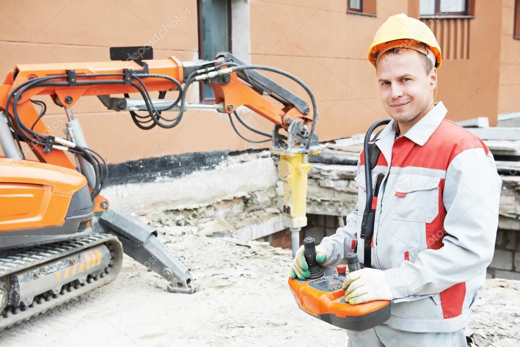 builder worker operating demolition machine