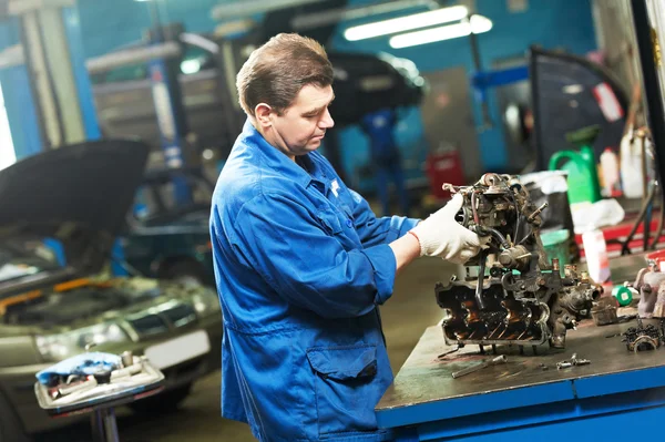 Mecánico de automóviles en el trabajo con el motor — Foto de Stock