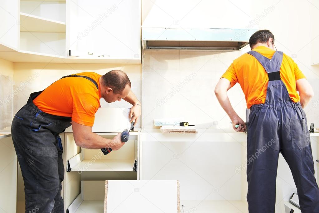 two kitchen installers at carpenter work