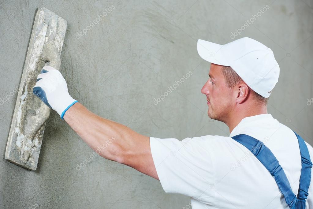 Plasterer at indoor wall work