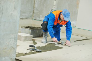 tilers at industrial floor tiling renovation clipart