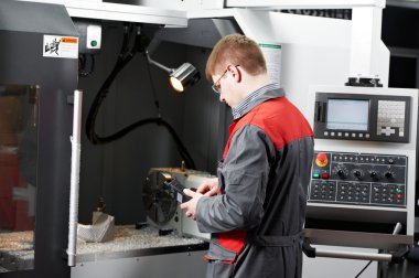 worker at machining tool workshop clipart