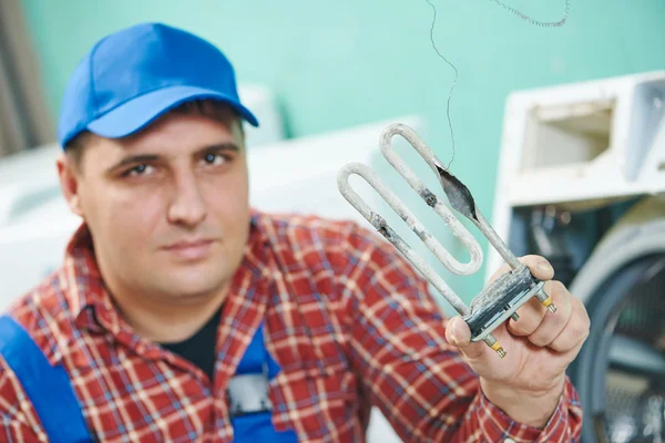 Replacing turbular electric heating element of washing machine — Stock Photo, Image