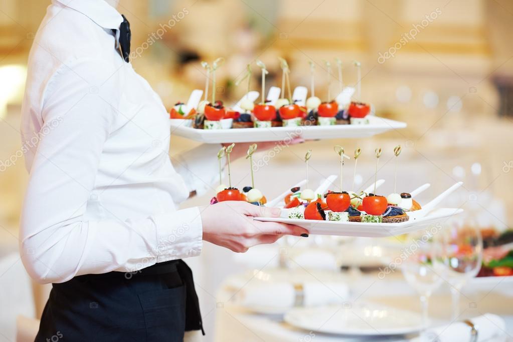 Waitress serving banquet table