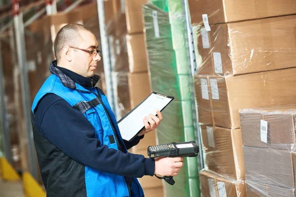 Worker man scanning package in warehouse — Stock Photo, Image
