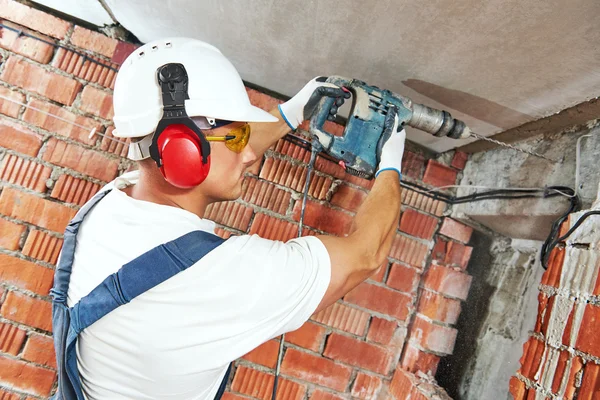 Construction worker with drill perforator — Stock Photo, Image