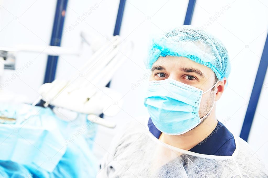 Portrait of dentist  wearing surgical mask and cap