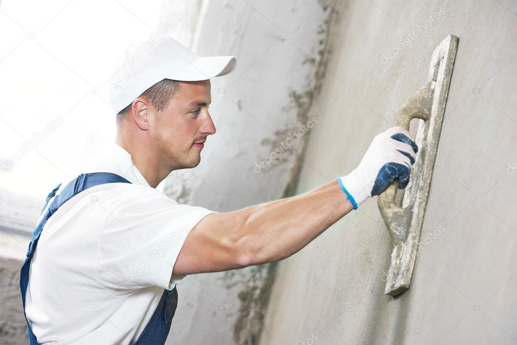 Plasterer at indoor wall renovation