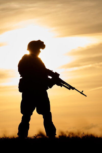 Military soldier silhouette with machine gun