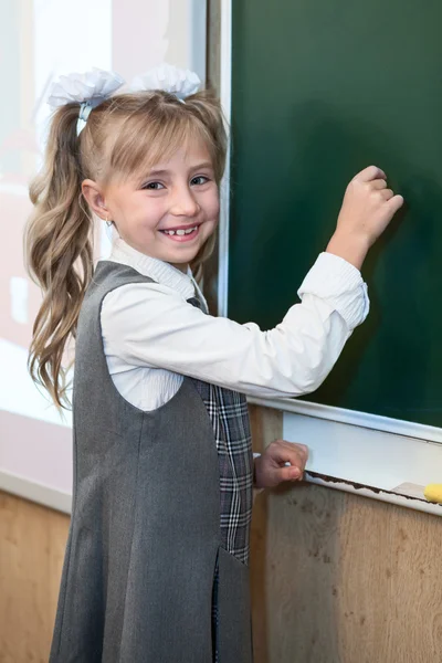 Leende Skolflicka Skriva Med Krita Grön Svarta Tavlan — Stockfoto