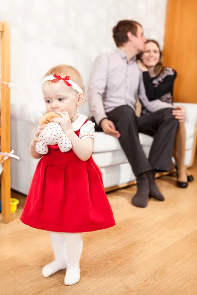 Caucasian Baby Girl Red Dress Standing Embracing Parents Background — Stock Photo, Image