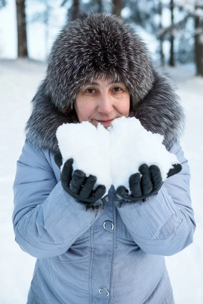 Portrait Smiling Mature Caucasian Woman Snow Hands Stock Photo