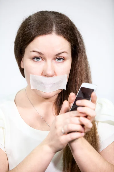 Caucasian Woman Mouth Sealed Tape Holding Cell Phone Hands Grey — Stock Photo, Image