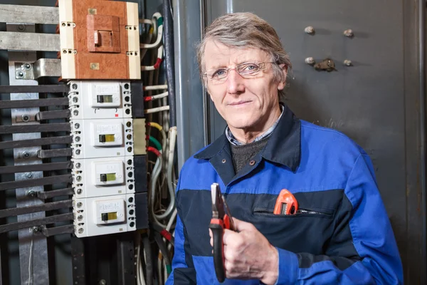 Senior Caucasian Electrician Pliers His Hands Standing High Voltage Panel — Stock Photo, Image