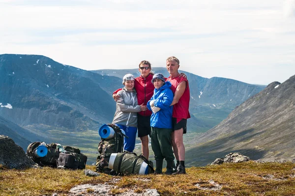 Vier mensen familie staande op de top van berg pass samen, samen wandelen — Stockfoto