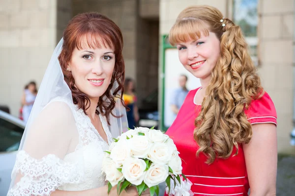 Happy smiling bride with bridesmaid — Stok Foto
