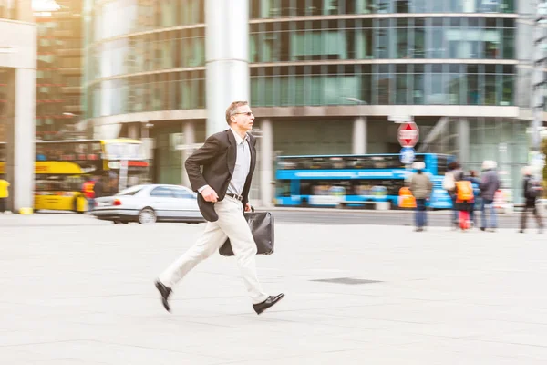 Businessman running in the city, panning image — Stock Photo, Image