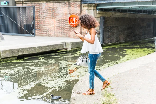 Junge Frau in London spielt mit Augmented-Reality-Anwendung — Stockfoto