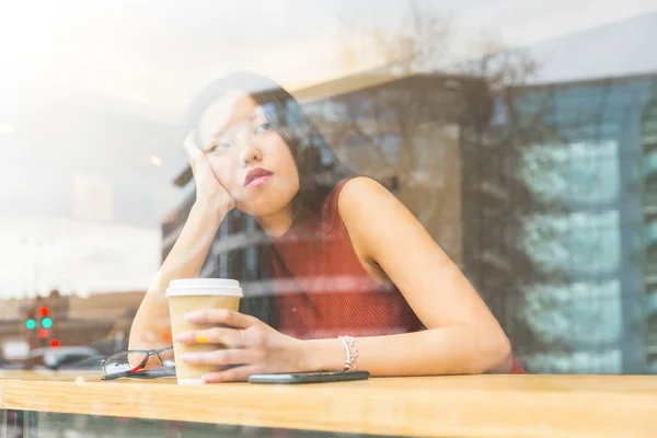 Sad Chinese woman in a cafe — Stock Photo, Image