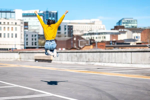 Successful Black Woman Celebrating Jumping Young Woman Wearing Yellow Top — Φωτογραφία Αρχείου