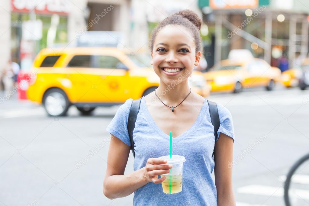 Beautiful Young Woman with Refreshing Drink in New York