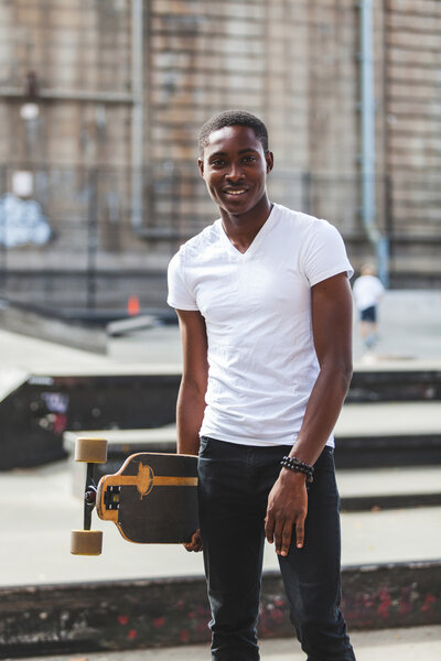 Black Boy with Longboard at Park