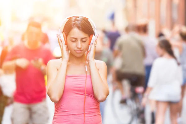 Schöne junge Frau hört Musik — Stockfoto