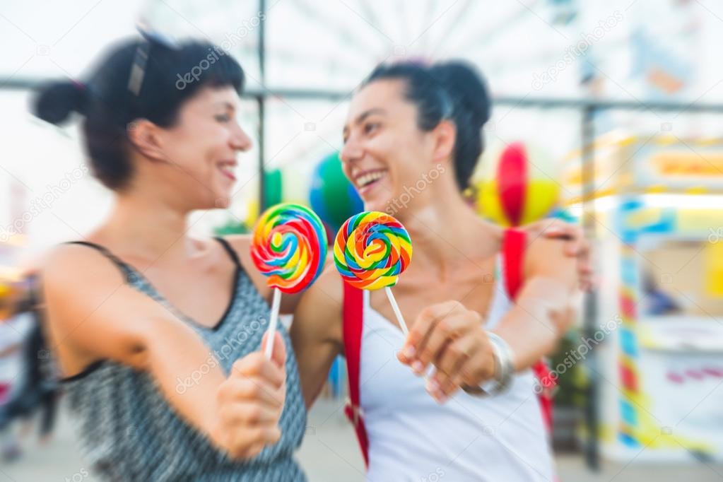 Happy Young Women eating Lollipop
