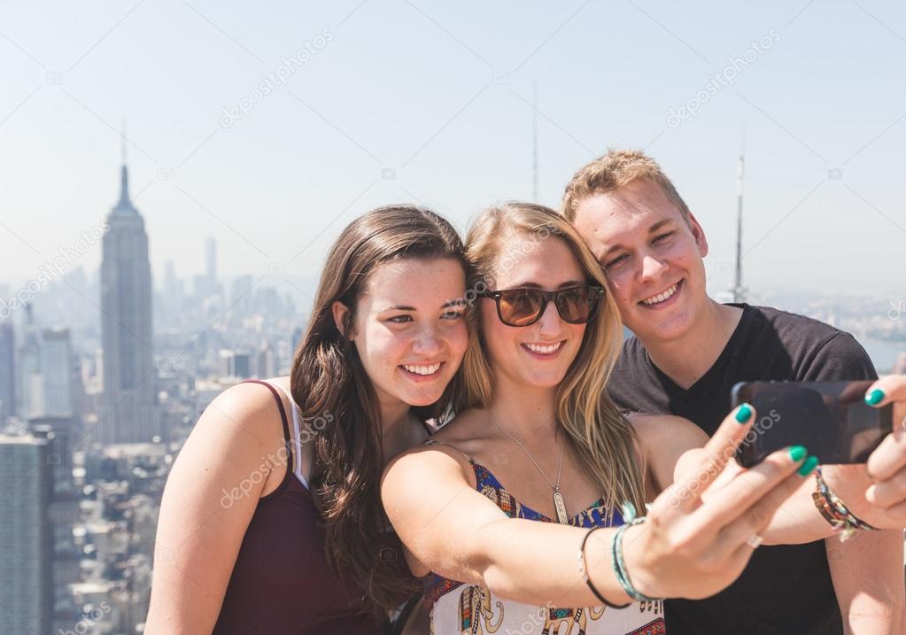 Friends Taking Selfie with New York on Background