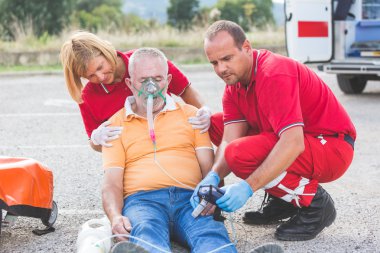 Rescue Team Providing First Aid clipart