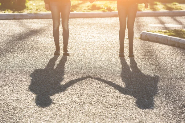 Shadows of Female Twins Holding Hands in the City. — Stock Photo, Image