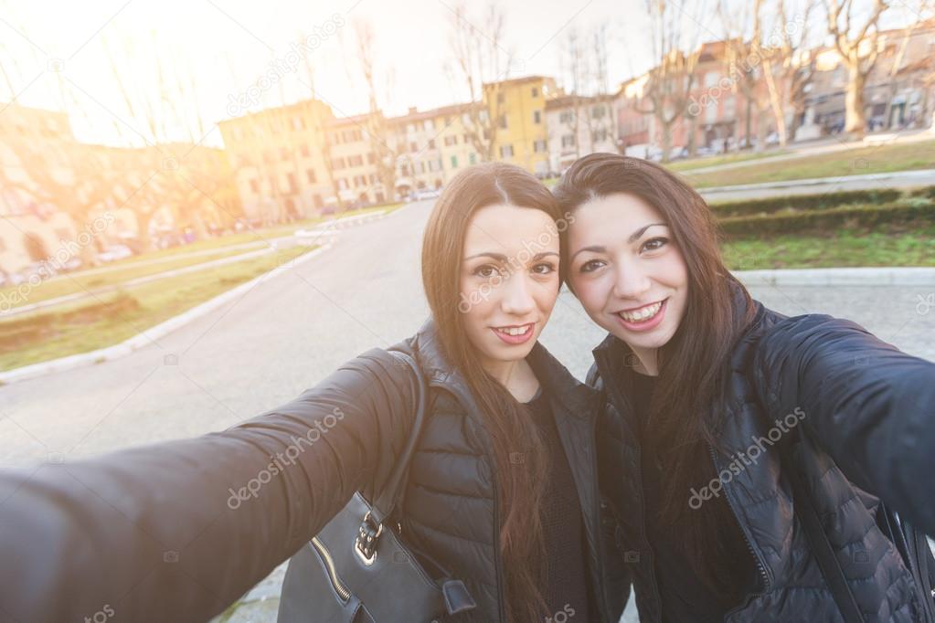 Female Twins Taking a Selfie in the City.