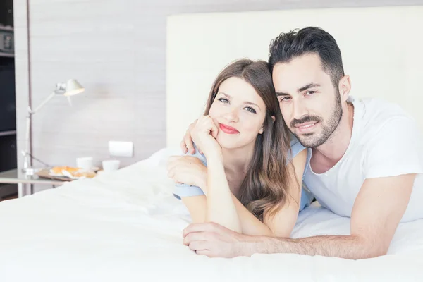 Young couple embraced on the bed — Stock Photo, Image