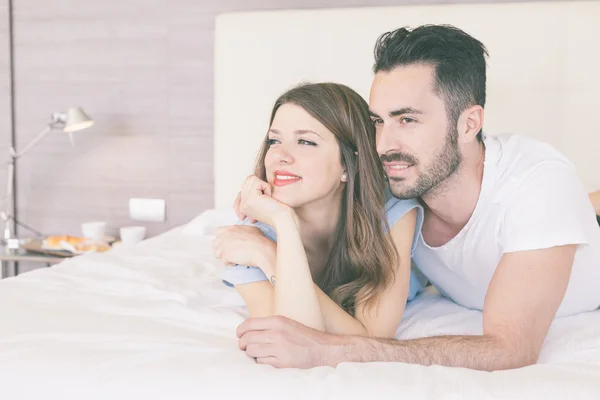 Young couple embraced on the bed — Stock Photo, Image