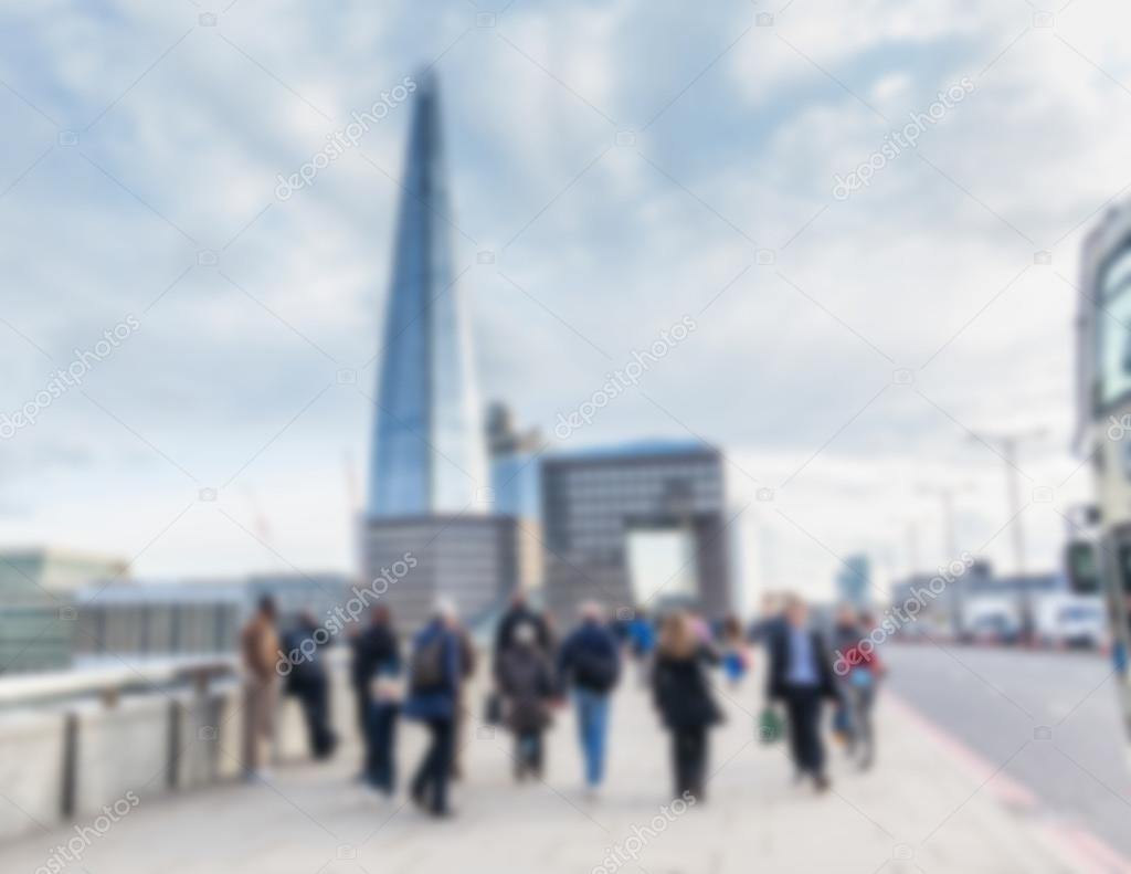 Blurred background, tourists and commuters walking on London Bri