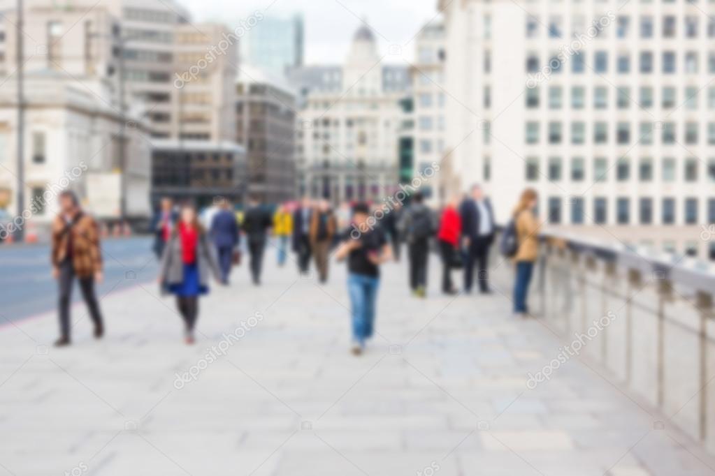 Blurred background, tourists and commuters walking on London Bri
