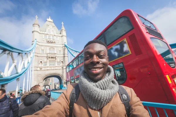 Man taking selfie in London with Tower Bridge on background — Stok fotoğraf