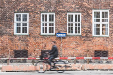 Blurred person going by bike in Copenhagen clipart