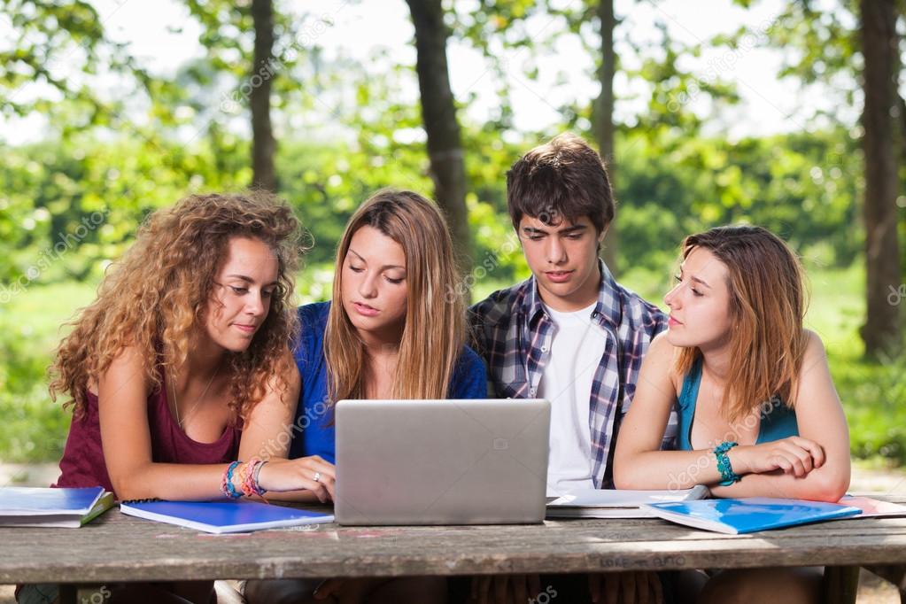 Students at Park with Computer and Books