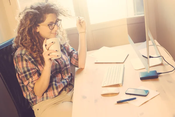 Young woman working at home or in a small office — Stock Photo, Image