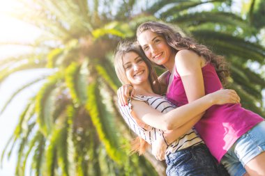 Portrait of two beautiful girls at park