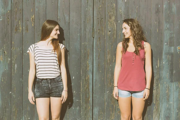 Portrait de deux belles filles avec fond en bois — Photo