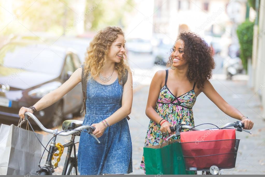 Multiracial couple of friends with bikes.