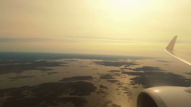 Flugzeug fliegt im Tiefflug über Meer und Inseln bei Sonnenuntergang — Stockvideo