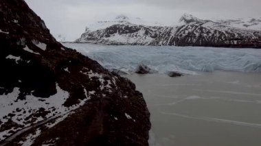 Aerial view of glacier and lake with iceberg floating on the water on a winter day in Iceland - Nature and travel concepts.
